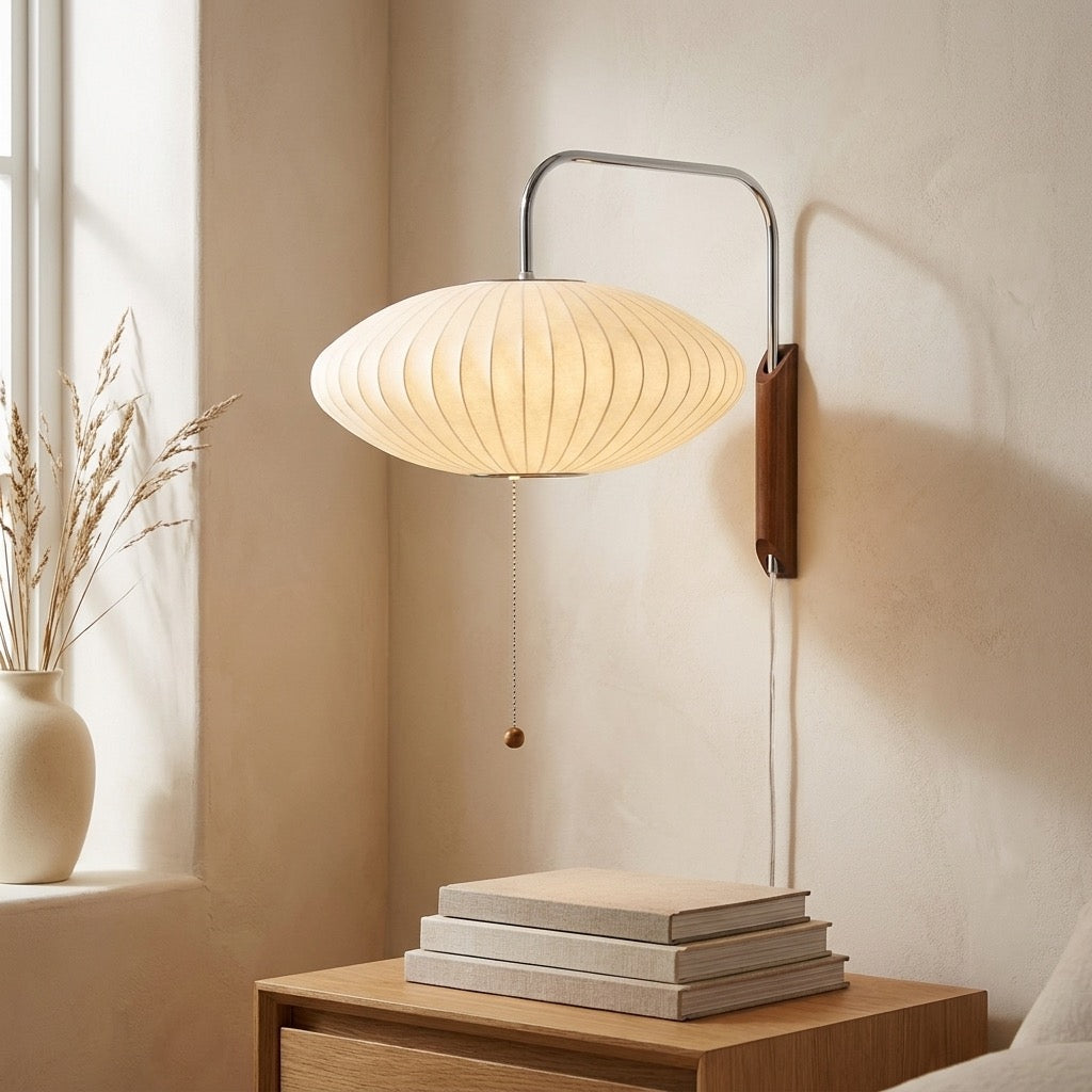 Side view of saucer wall lamp showing slim curved chrome-tone arm and wood bracket