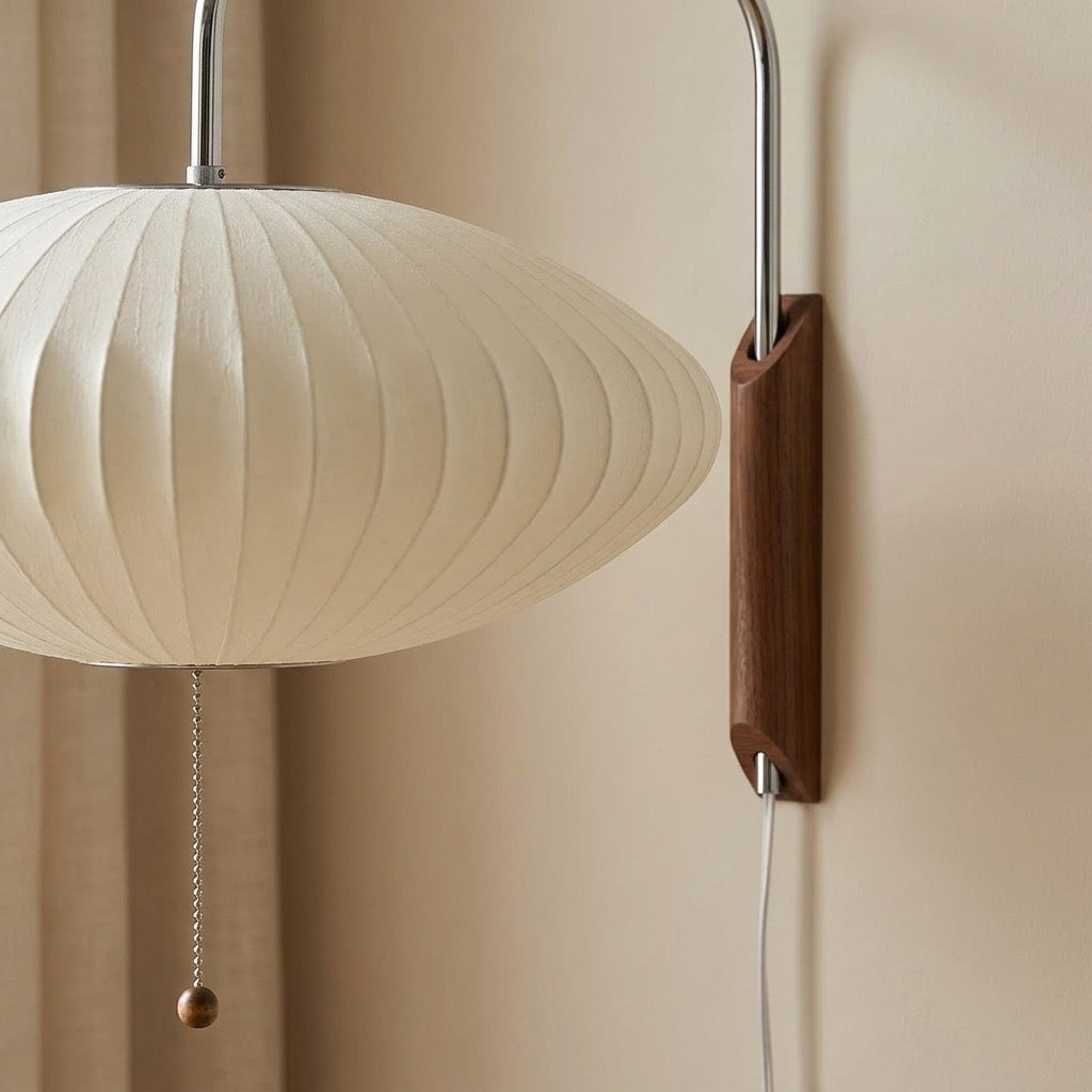Close-up of pleated silk-effect shade folds on the flying-saucer wall lamp