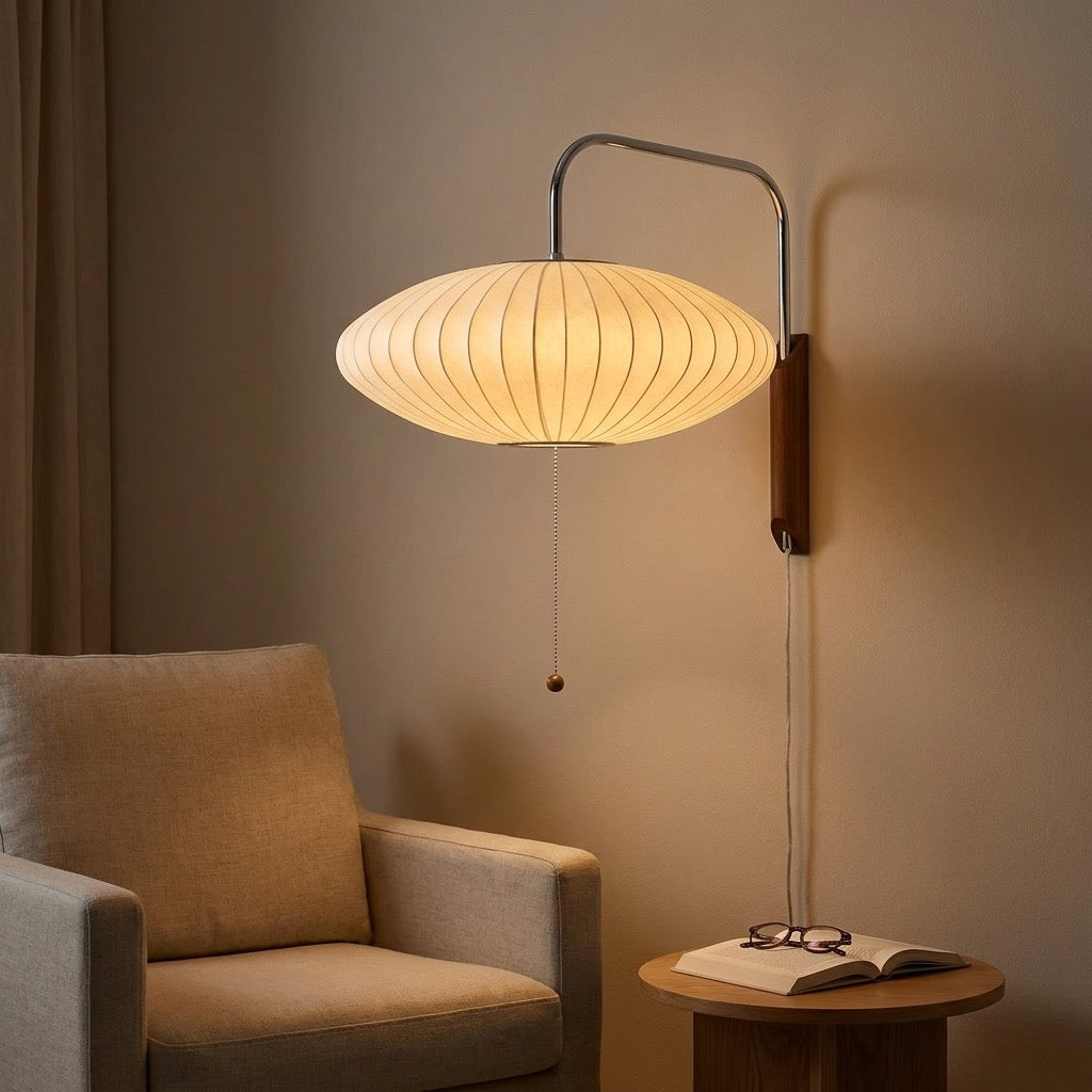 Pair of saucer silk-effect wall lamps with chrome arms in a living room
