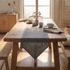 Khaki woven linen-look runner layered under a ceramic vase and candles