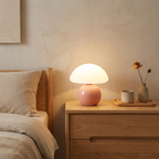 Pink-base mushroom lamp glowing on a bedroom dresser