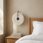 Alabaster-look moon disc sconce in a minimalist interior setting