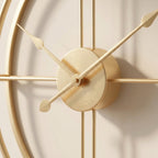 Open double-ring gold-tone clock styled in a modern living room