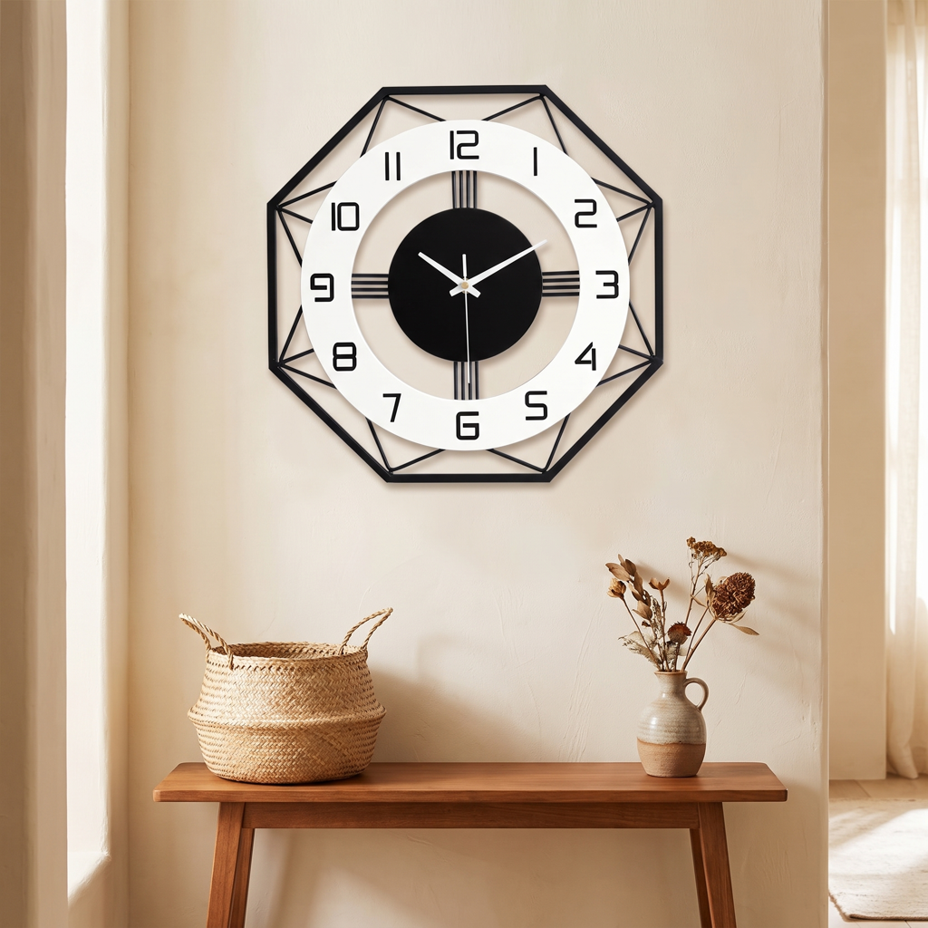 Geometric metal wall clock above a console table in a warm entryway