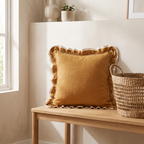 Mustard woven cushion cover with frill edge on an entryway bench