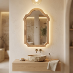 Vintage arched wood-framed mirror above a bathroom vanity with a stone basin
