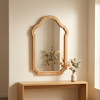 Vintage arched wood-framed mirror above an entryway console table