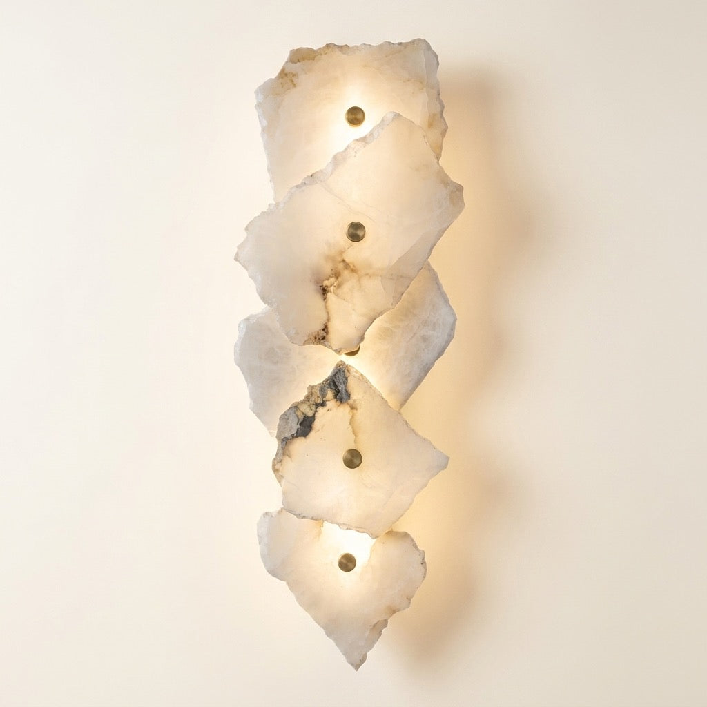 Stacked five-slab translucent stone-look wall sconce with brass-tone fitting and warm backlit glow.