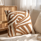 Neutral cushion cover layered with oatmeal and taupe pillows