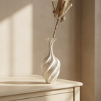 Hand holding the white metal swirl vase to show its slim scale