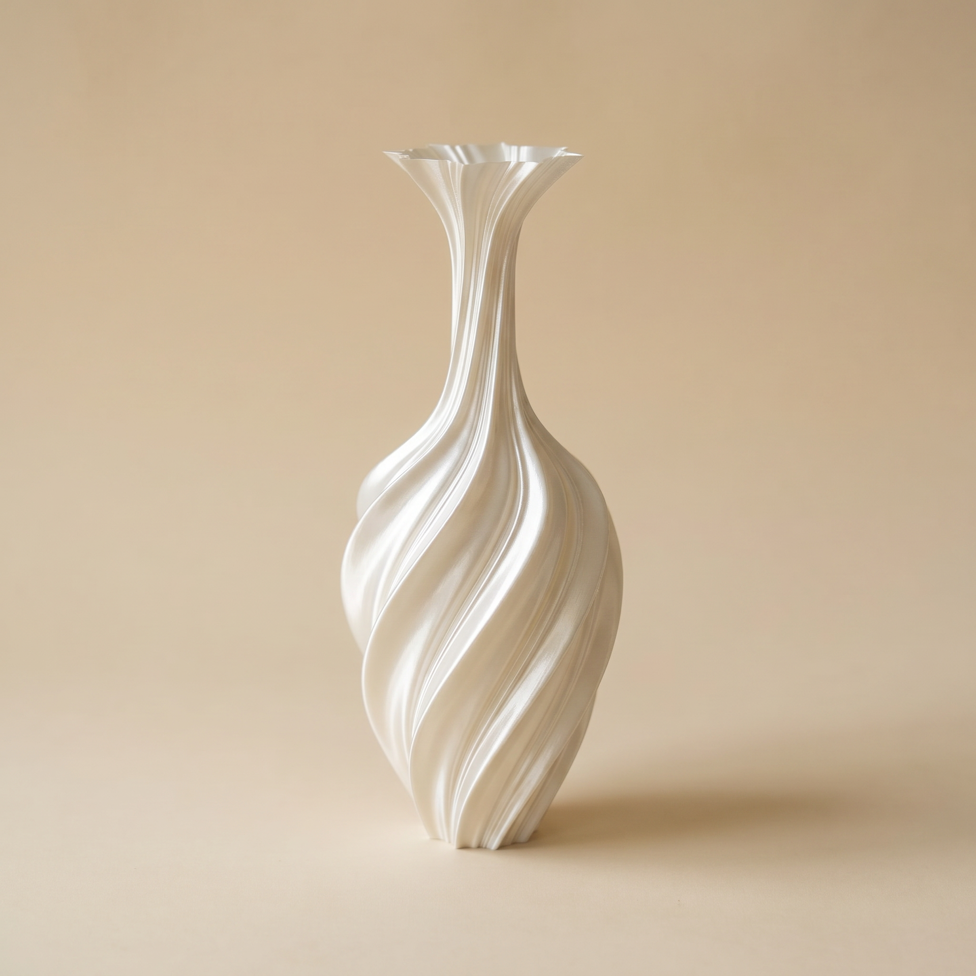 White sculptural swirl metal vase casting a soft shadow in sunlight