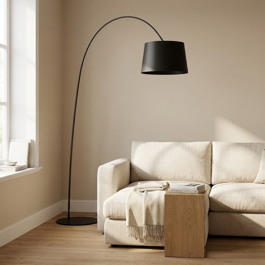 Close-up of the inverted-cone metal shade and slim curved matte-black arm of the arc floor lamp