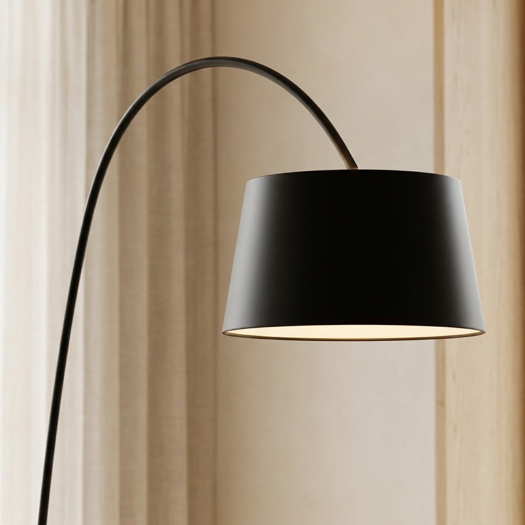 Thin round disc base of the matte-black Nordic arc floor lamp on the floor
