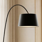 Thin round disc base of the matte-black Nordic arc floor lamp on the floor