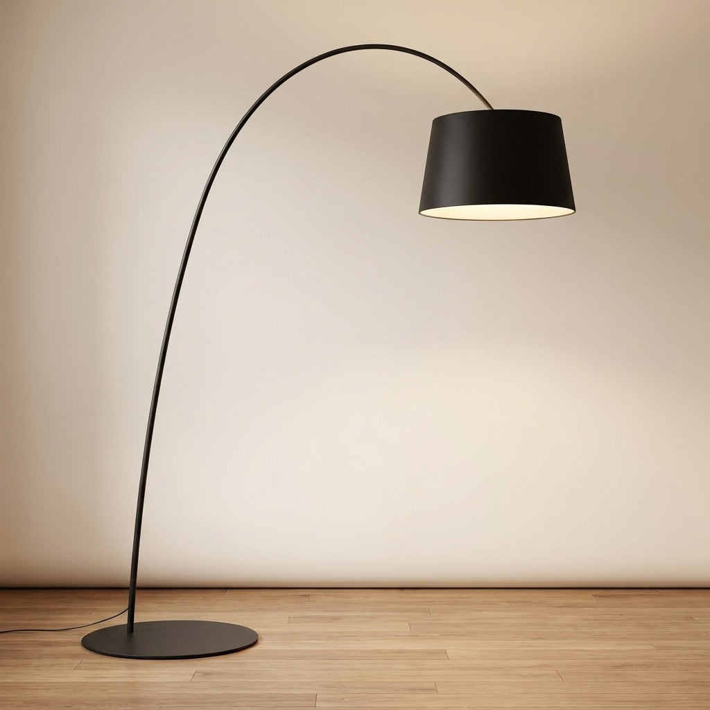 Arc floor lamp arching over a seating area, delivering soft overhead reading light