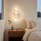 Nordic Music-Note LED Wall Sconce in white above a bedside nightstand