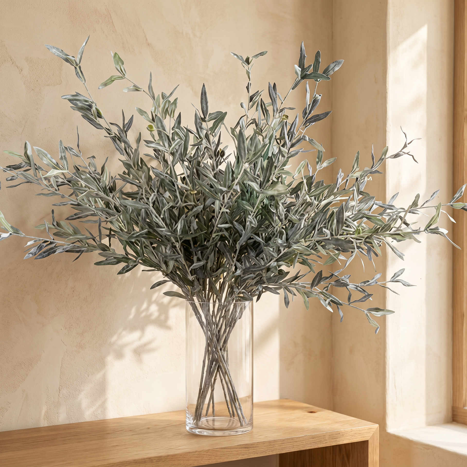 Close-up of realistic muted-green olive leaves on a faux stem