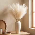 Multiple faux pampas stems gathered loosely in a woven floor basket