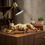Gold prowling panther resin sculpture on a home office credenza beside a lamp