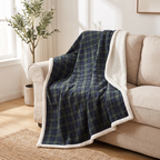 Green-navy tartan plaid throw with sherpa reverse draped on a sofa