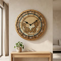 Golden world-map gear wall clock mounted on a beige wall above a wood console with a plant