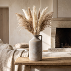 Tall bottle ceramic vase styled on a console table