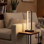 Black LED frame table lamp on a side table beside a linen sofa in a cozy living room