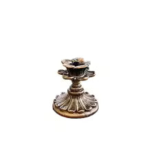 Style 3 vintage bronze taper candle holder shown against a neutral studio backdrop