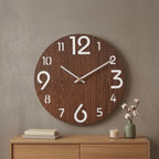 Dark walnut Nordic wall clock with white numerals and white hands in a cozy living room