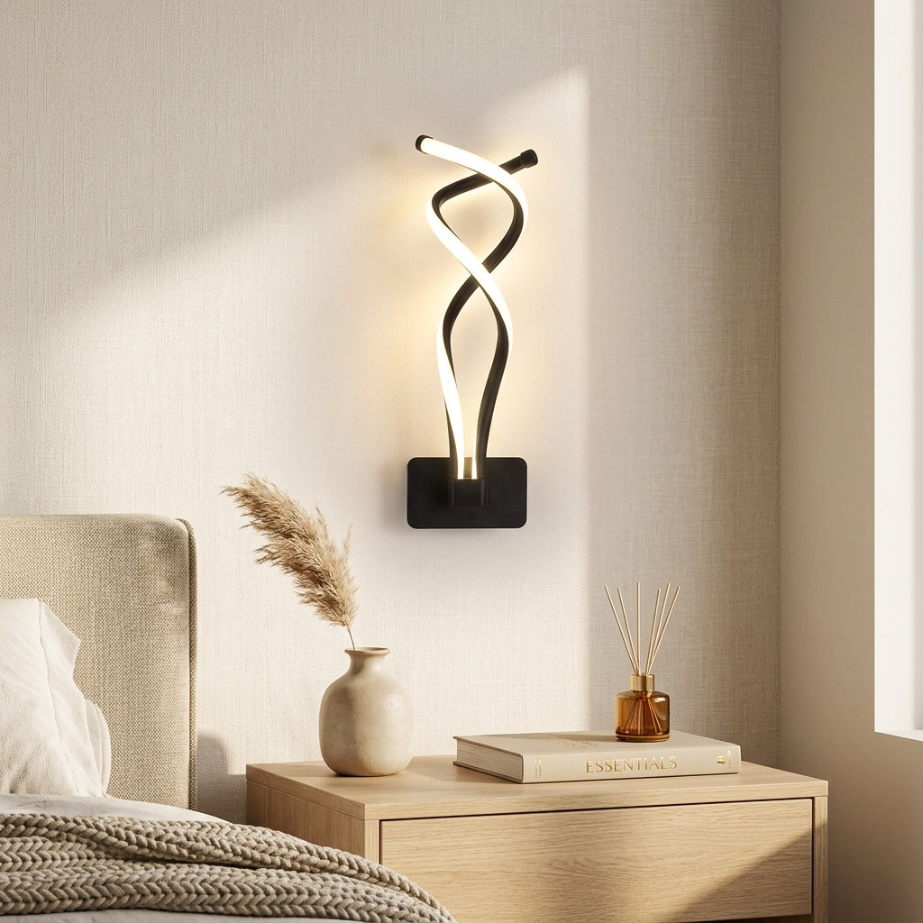 Nordic Twisted-Ribbon LED Wall Sconce in black above a bedside nightstand