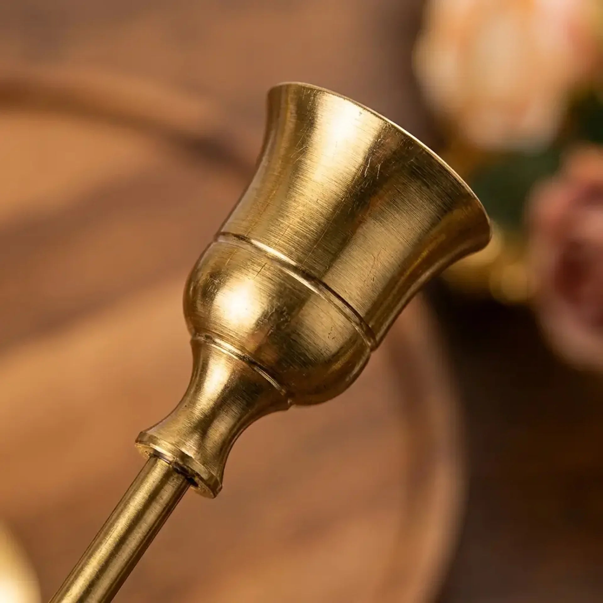 Set of three vintage tapered metal candle holders in graduated heights — material and form close-up