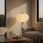 Rice paper lantern floor lamp at dusk in a minimalist living room