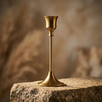 Set of three vintage tapered metal candle holders in graduated heights — dramatic low-angle hero shot