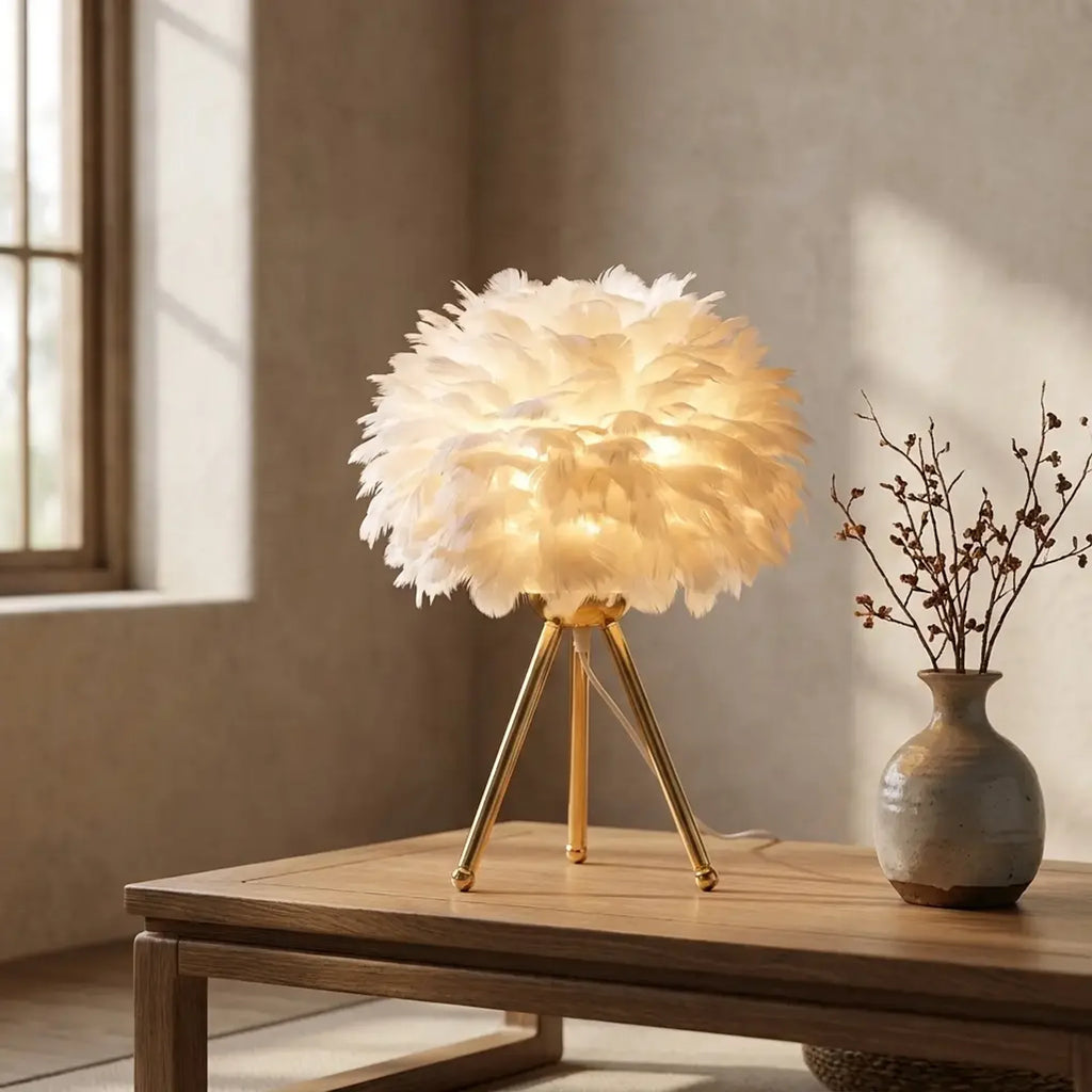 Feather plume shade and brushed brass stand close-up detail