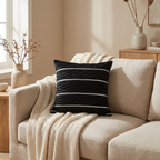 Black pleated velvet cushion cover on a linen sofa