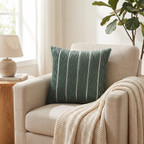 Green pleated velvet cushion cover on a linen armchair