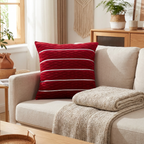 Wine-red pleated velvet cushion cover on a linen sofa