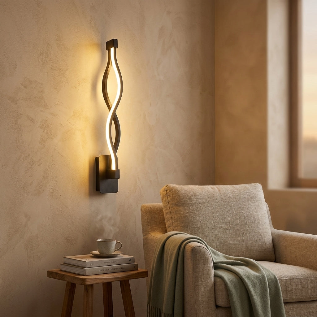 Nordic Wave LED Wall Sconce in black beside a reading chair