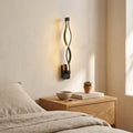 Nordic Wave LED Wall Sconce in black above a bedside nightstand
