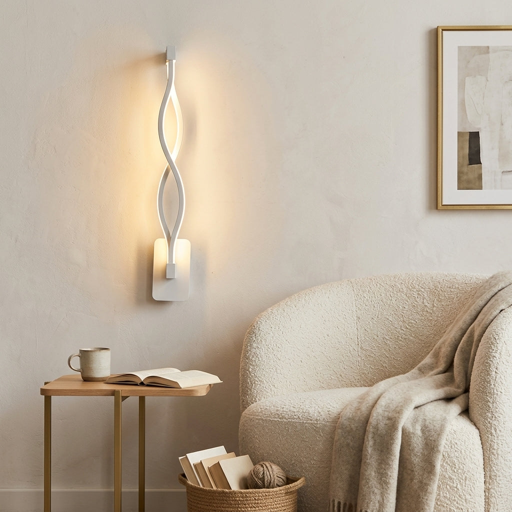 Nordic Wave LED Wall Sconce in white beside a reading chair