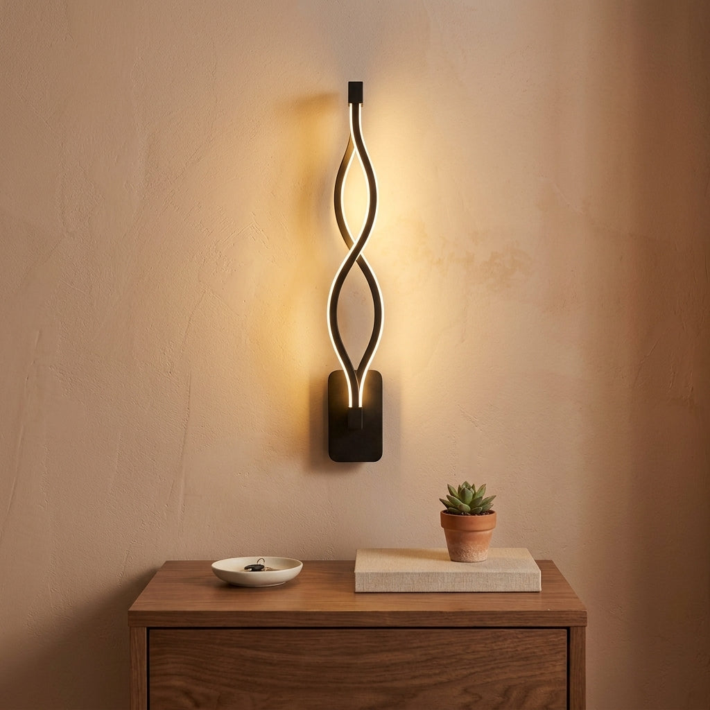 Nordic Wave LED Wall Sconce in black on a rectangular wall plate above a walnut nightstand
