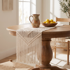 Cream geometric macramé table runner on a pedestal table with lemons and a pitcher