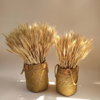 Bundle of 100 dried wheat stalks arranged in a tall ceramic vase on a console table