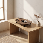 Solid wood valet tray with a few rings and a folded note on a nightstand